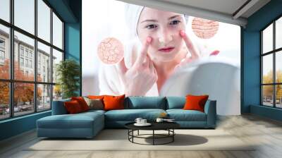 Woman looking at her dry skin with cracks and with first wrinkles. Circles increase the skin like a magnifying magnifier Wall mural