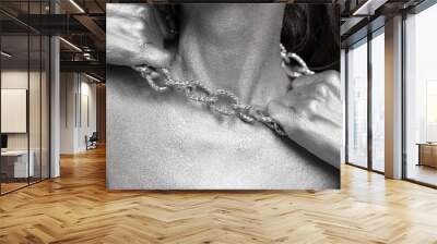 Beautiful woman with silver paint on her skin and hair breaks the chain around her neck. Wall mural