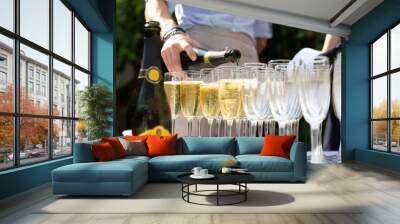 Rows of champagne flutes on bar counter Wall mural