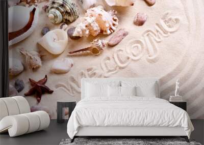 seashells in sand with text Wall mural