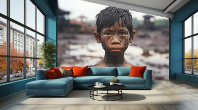 Disheartened Skinny Asian Boy Covered in Mud Stands Sadly, Looking at the Camera Wall mural