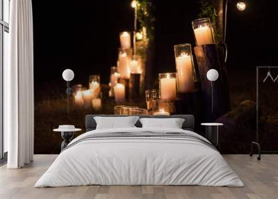 Candles in glass flasks in the decoration of the night ceremony Wall mural