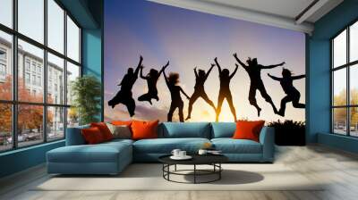 Group of people jumping against the sunset Wall mural