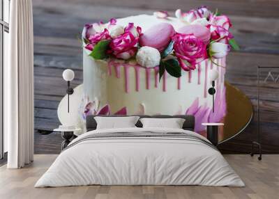 white cake with a rose decoration on a wooden background Wall mural