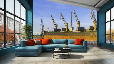 Container cargo freight ship with working crane bridge at shipyard in morning for logistic import and export background Wall mural