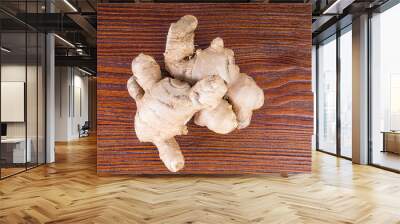 Fresh ginger root on wooden table Wall mural