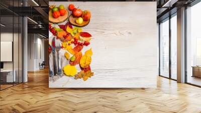 Thanksgiving dinner background with pumpkins, fall leaves, table setting, physalis, top view, copy space. Banner Wall mural