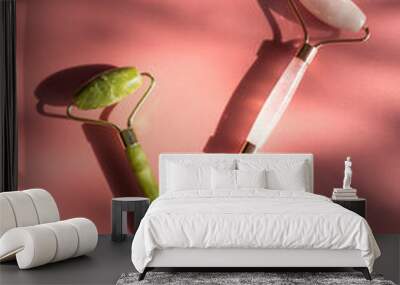 Two stone jade rollers on pink background Wall mural