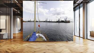 yacht view on industrial. Large red cargo ship loading with a coal in the port, crane work in coal handling terminal Wall mural