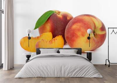 Two whole peaches with green leaf and slices (isolated) Wall mural