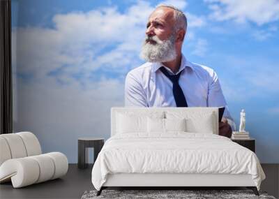 Bearded man against blue sky Wall mural