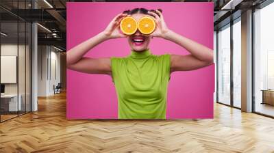 funny shot of girl with two pieces of orage on eyes Wall mural