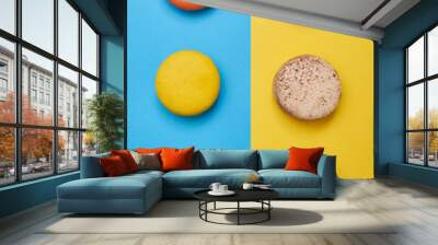 Top view of bright macaroons arranged in two line over blue flatlay Wall mural