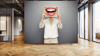 woman holding picture with big smile Wall mural