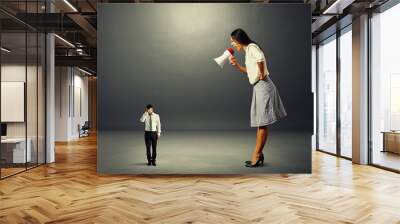 woman screaming at stressed businessman Wall mural