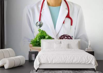 Doctor holding fresh fruit and vegetable, Healthy diet, Nutrition food as a prescription for good health. (Selective Focus) Wall mural