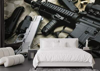 Weapons and military equipment for army, Assault rifle gun (M4A1) and pistol on camouflage background. Wall mural