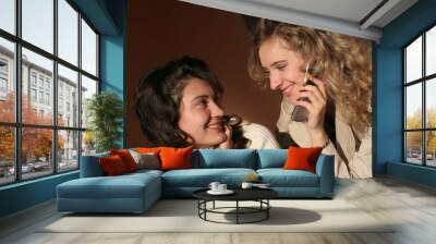 two young womans with mobile phone Wall mural