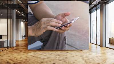 Man using mobile phone in the street., with copy space for text. Wall mural