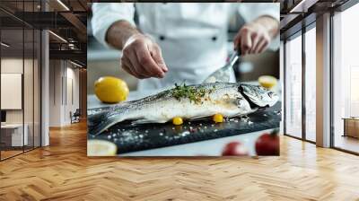 A chef preparing sea bass in a modern kitchen with a clean, uncluttered background. The open space around the fish provides ample text area. Wall mural