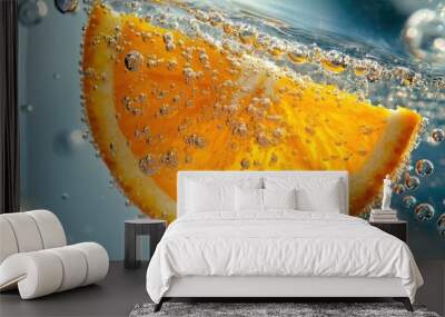 A juicy, bright orange slice floating in a glass of sparkling water, with bubbles rising to the surface. Wall mural