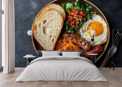 A top-down view of served with a side of Thai-style sausage, pickled vegetables, and a slice of crusty baguette, showcasing a delicious and satisfying breakfast plate. Wall mural