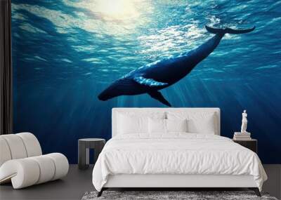 A whale diving into the depths of the ocean with a clear, unobstructed water surface above. The space around the whale is ideal for adding text. Wall mural