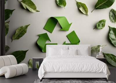 An elegant green waste recycling symbol accompanied by fresh leaves, positioned on a clean background for easy integration of environmental messages. Wall mural