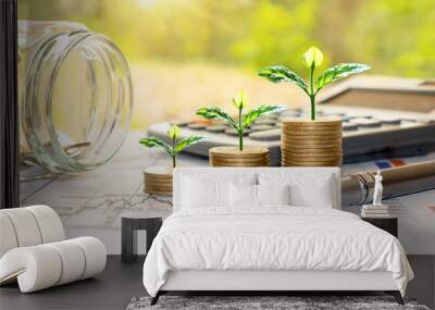 Plant trees on coins and calculators, financial accounting concepts and save money. Wall mural