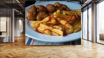 A plate of french fries and chicken  Wall mural