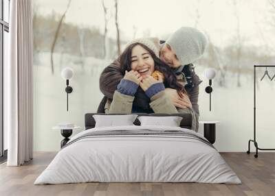 Cheerful young couple walking in a winter day Wall mural