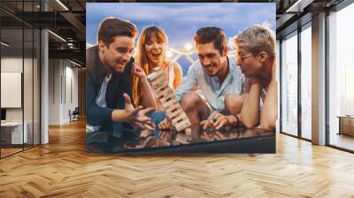 The company of young people playing jenga Wall mural