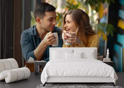 Young couple in love sitting in a cafe, drinking coffee Wall mural