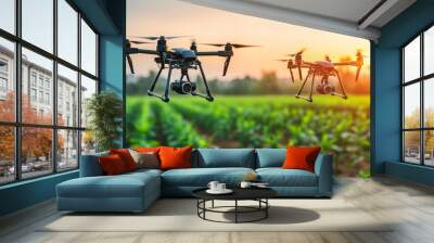 Two drones flying over agricultural field during a bright sunset Wall mural