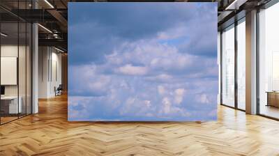 Blue heaven summer cloudscape. Rolling puffy white layered clouds are moving. Time lapse. Wall mural