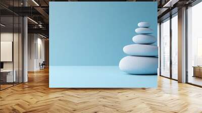 Balanced Zen Stone Stack on a Tranquil Blue Gradient Background Symbolizing Harmony and Serenity Wall mural