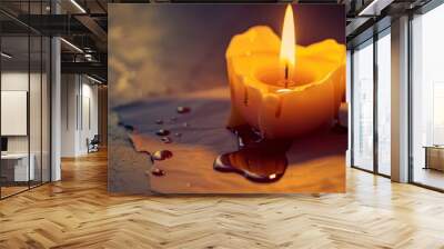 melting candle into heart shaped on a paper, light spreading around like a star Wall mural