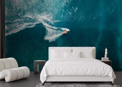 Aerial view with surfier riding on ocean wave. Perfect waves with surfers in ocean Wall mural