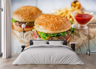 American hamburger with beef, sauce and french fries on wood background. Flat lay. Top view. Wall mural