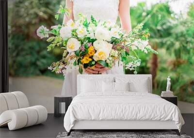 Bride in white dress with beautiful wedding bouquet. Wedding style. Wall mural