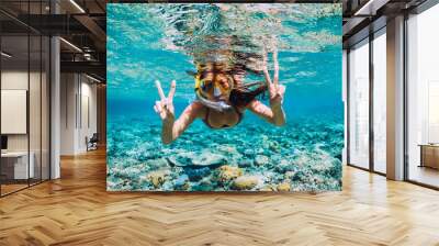 Happy young woman swimming underwater in the tropical ocean Wall mural