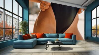 Sexy body of slim young woman in black bikini at beach Wall mural