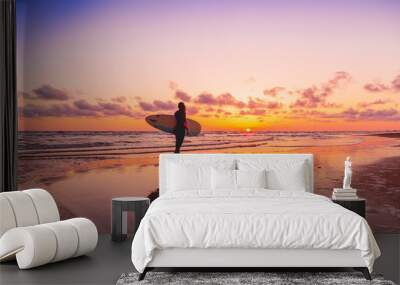 Silhouette and reflection of surfer girl with surfboard on a beach at sunset. Surfer and ocean Wall mural