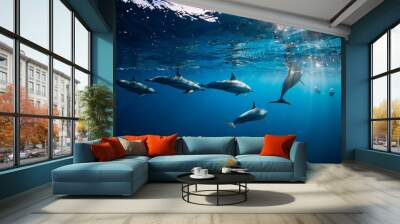 Spinner dolphins underwater in blue ocean. Dolphin family Wall mural