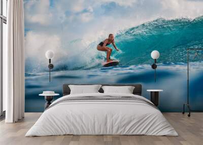 Surf girl on surfboard. Surfer woman and blue wave Wall mural