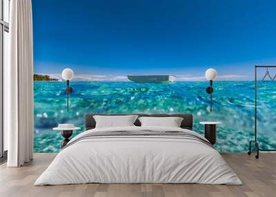 Turquoise ocean with sandy bottom in tropics and fishing boat Wall mural