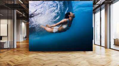 Woman dive without surfboard with ocean wave. Duck dive under barrel wave Wall mural