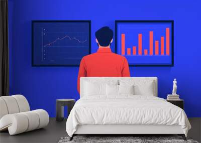 A person in a red jacket analyzes charts displayed on two screens against a vibrant blue background, focusing on data visualization and interpretation. Wall mural