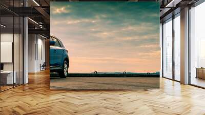 blue compact suv car with sport and modern design parked on concrete road by the sea. hybrid and ele Wall mural