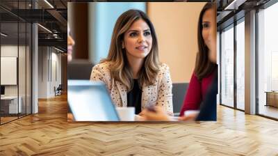 Empowered Hispanic businesswomen. Diverse group collaborating in modern meeting room, exchanging innovative ideas. Professional attire and utilizing laptops. Workplace diversity and female leadership. Wall mural